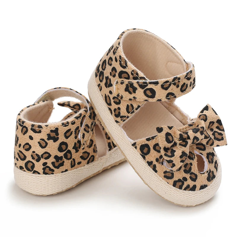 Pair of leopard print baby first walkers with soft rubber soles