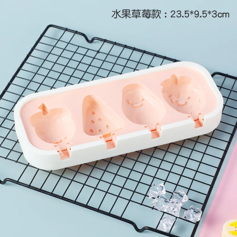 A white silicone mold tray containing four pink popsicle shapes on a black wire rack.
