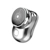 A close-up view of a silver electric shaver with a mesh head and body, shown against a white background.