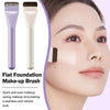 A flat foundation make-up brush shown next to a cosmetic pad being applied to a woman's face.