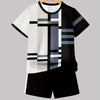 A black and white colorblock short sleeve t-shirt and matching shorts set displayed on a hanger.