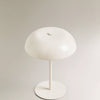 A white portable touch table lamp with a dome-shaped shade and a slender stand.