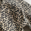Close-up of a boys' leopard print denim jacket showing the fabric texture and stitching.