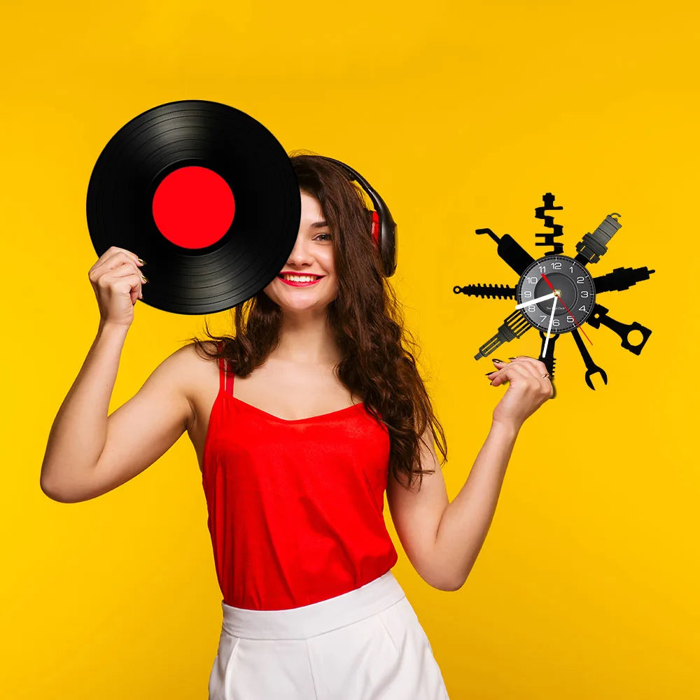 A smiling woman holding a black vinyl record and a vintage wall clock with gears against a yellow background.