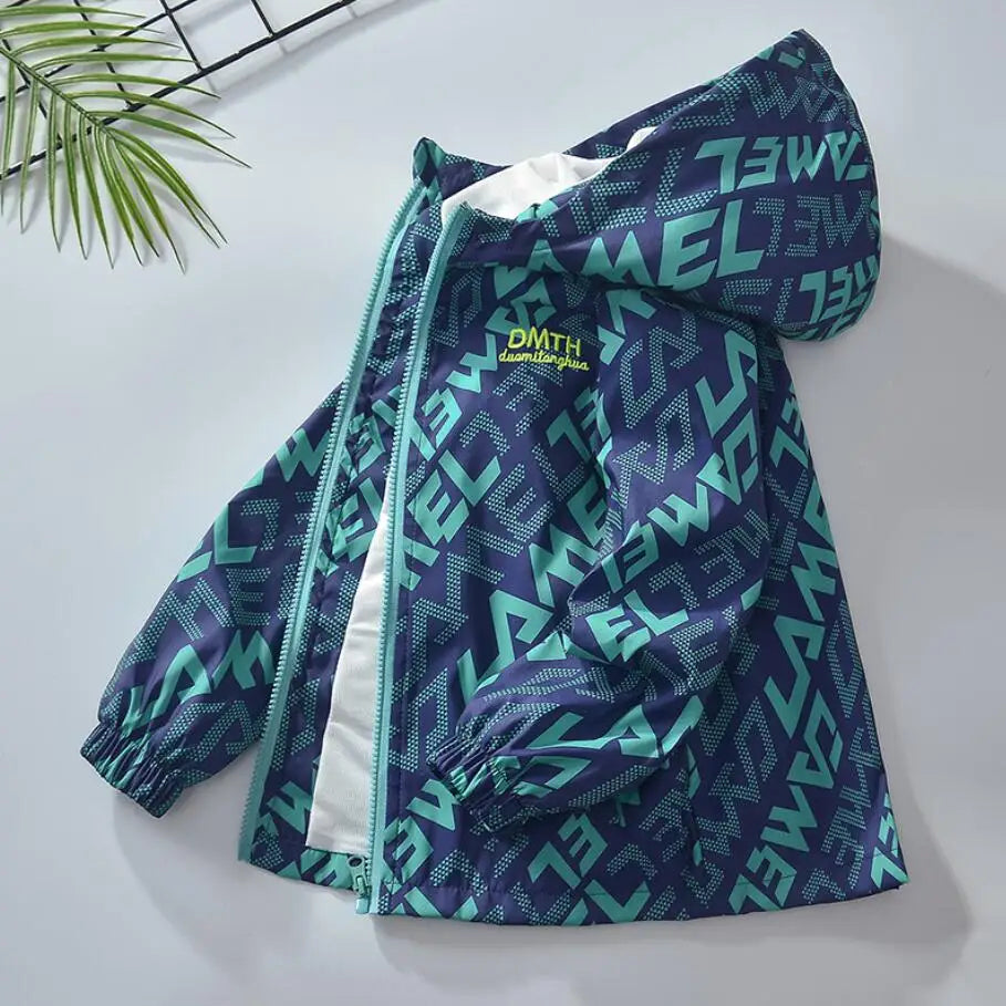 A dark blue and teal waterproof hooded jacket for kids lying on a white surface.
