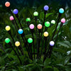 Fixed multicolor solar Firefly light globes among green foliage
