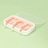 A white silicone mold tray with a clear lid containing three pink popsicle molds.