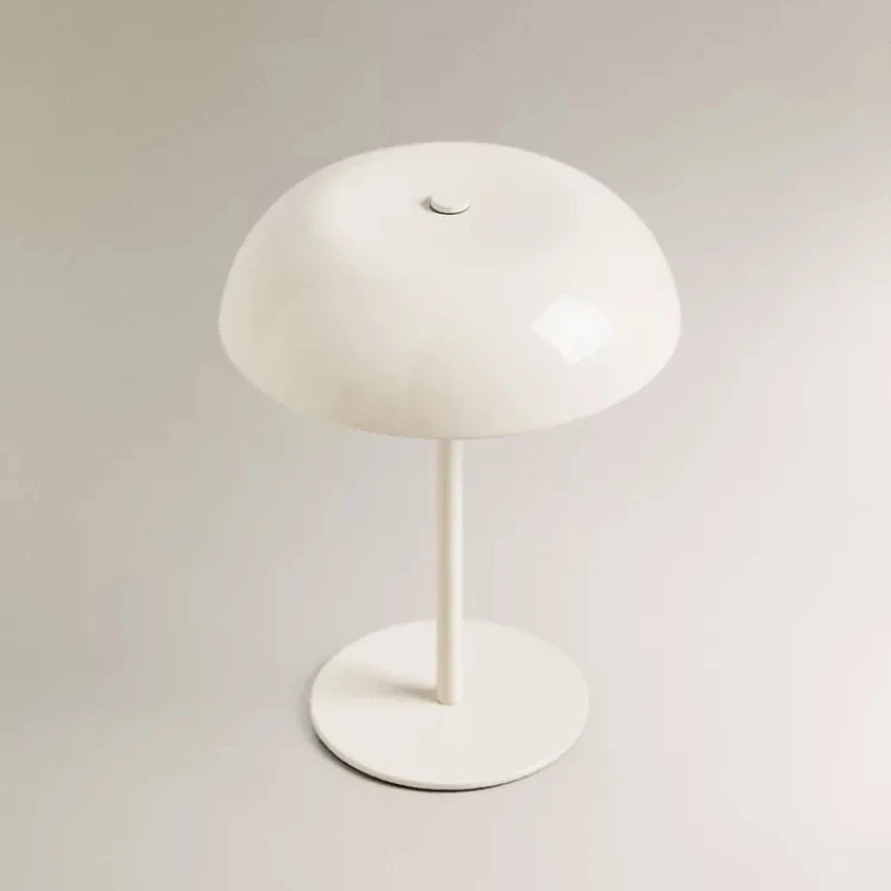 A white, dome-shaped portable touch table lamp with a slender stand.