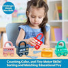 A young girl is playing with a red car-shaped puzzle lock toy and key, surrounded by other sorting and matching educational t