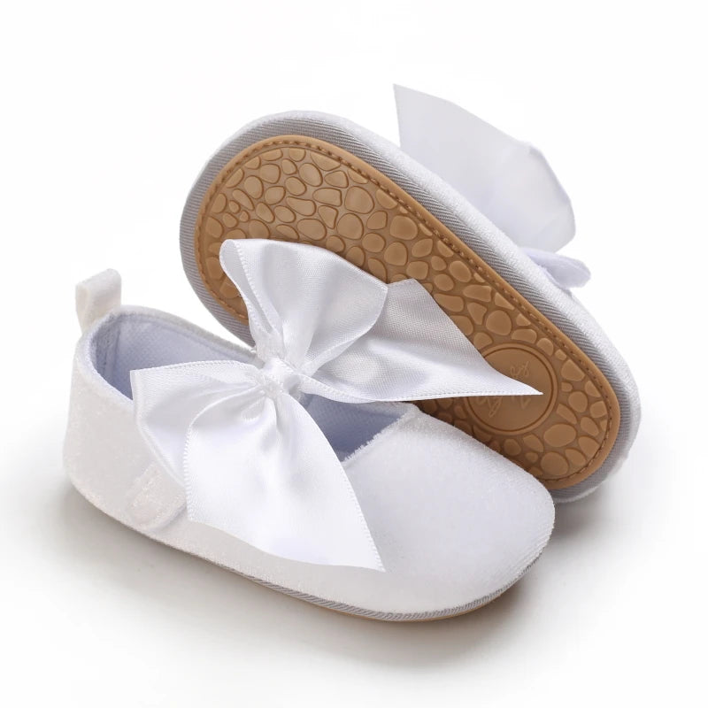 White soft non-slip baby first walker shoes with a satin bow detail