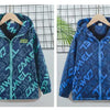 A blue and teal waterproof hooded jacket for kids displayed on a hanger against a grid background.