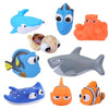 A collection of various floating animal bath toys including a blue whale, a blue fish, an orange octopus, and a gray shark.