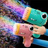 A hand holds a pink dinosaur bubble gun, which is blowing colorful bubbles against a black background.