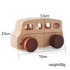 A light wooden toy cart with round wheels and window cutouts, measuring 5.5cm long and weighing 83g.