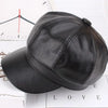 A black PU leather beret hat is shown resting on a white surface next to a clock face.