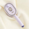 A light purple ionic steam hair brush with a smooth body and a silicone tip is shown against a cream-colored fabric.
