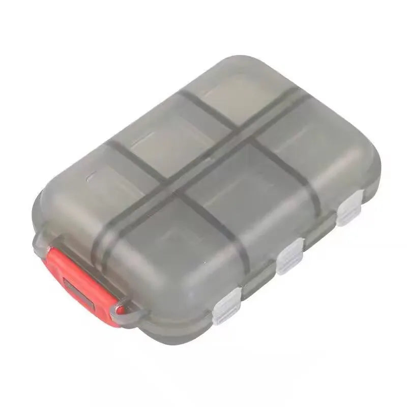 A gray, compact 12-compartment travel pill organizer with a red accent.