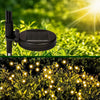 Integrated solar panel detail and warm-white garden lights at night