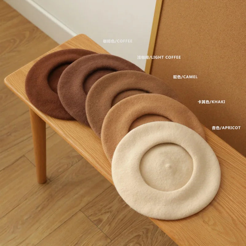 A collection of classic wool beret hats in various shades including coffee, light coffee, camel, khaki, and apricot displayed