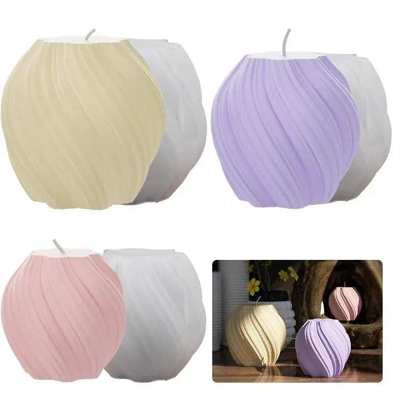 A set of three pillar candles in silicone molds featuring geometric wave patterns in cream, lavender, and pink.