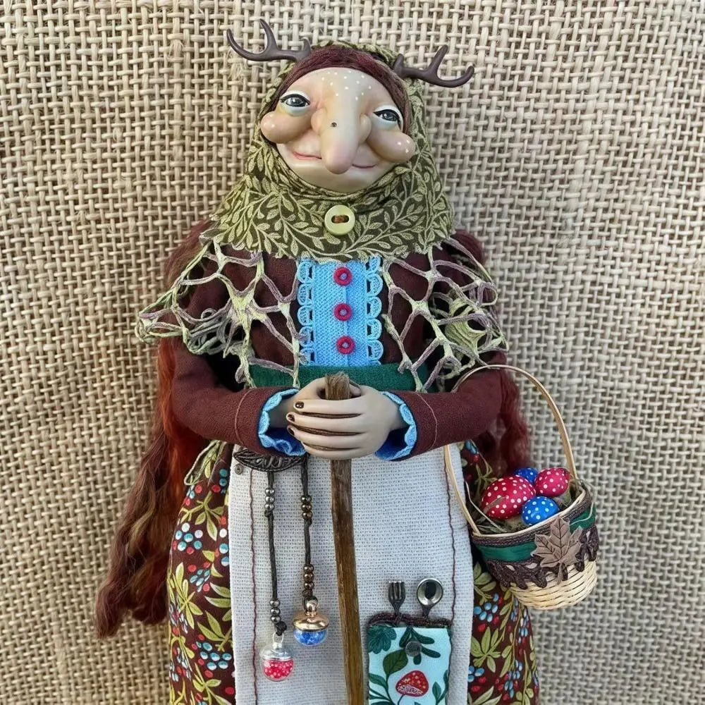 Handcrafted kitchen witch doll with antique charm featuring a horned face, knitted clothing, and a basket of berries.