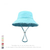 Light blue wide-brim bucket hat with frayed edges and a thin blue cord detail.