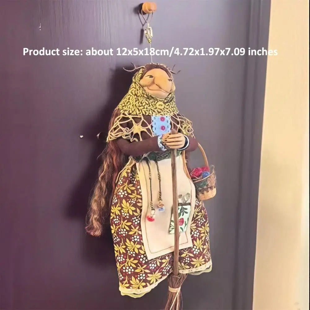Handcrafted kitchen witch doll with antique charm featuring a brown and gold outfit and long hair