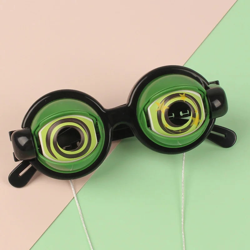 A pair of novelty funny glasses with green frames and yellow accents are shown against a light pink and green background.