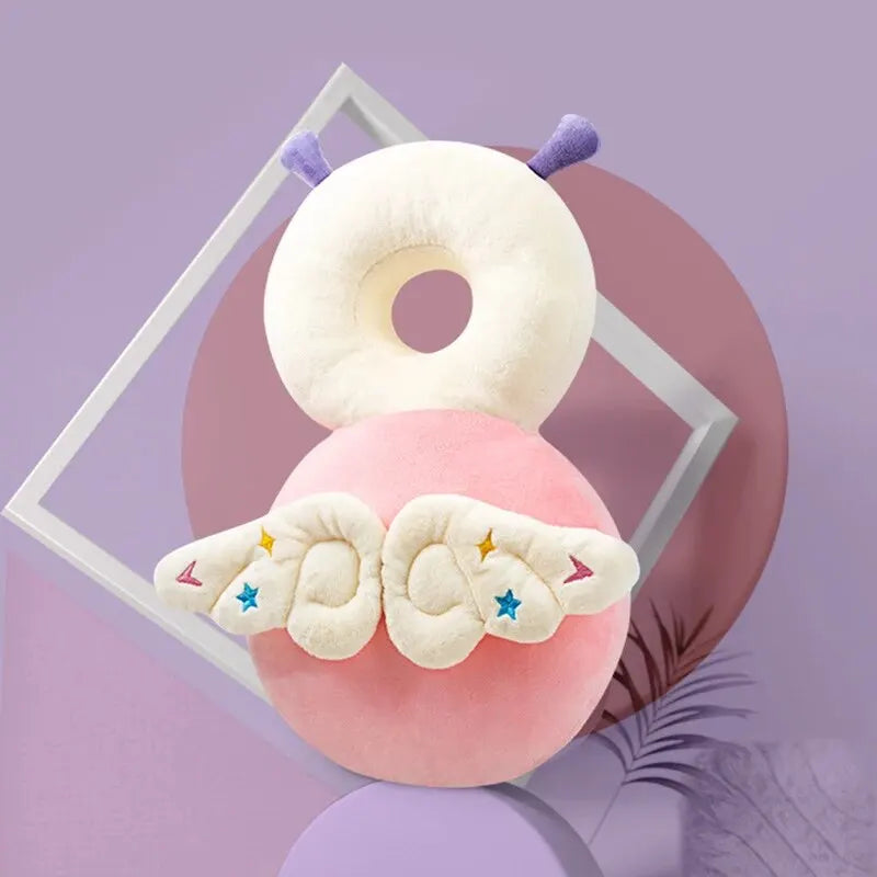A fluffy white and pink pillow shaped like a cloud with small wings, set against a purple background.
