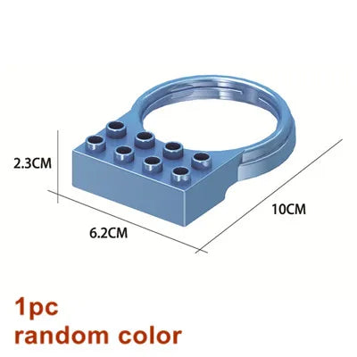 A blue marble run building block piece with a circular opening and multiple small holes.