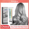 Schachtel und Tube der Hoegoa Silver Dye permanenten Haarfarbe, angewendet auf einer langen, hellgrauen Damenfrisur.