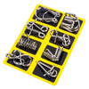 A yellow plastic tray holding eight different metal wire puzzle clasps and brain teasers.
