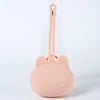 A pink silicone pacifier storage case with a rounded bear design and a long attached lanyard.