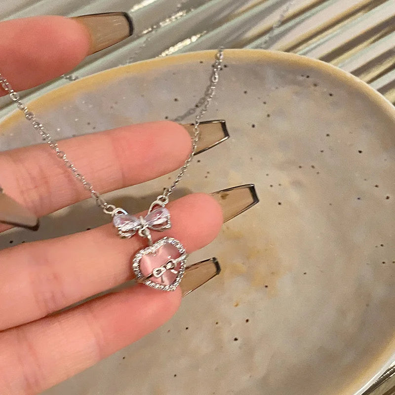 Silver heart pendant necklace with crystal bow angel wings on a delicate chain