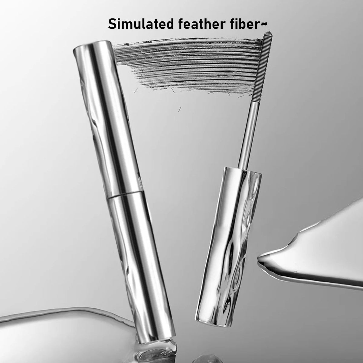 A close-up view of a silver mascara tube with a defining brush, showing simulated feather fibers.