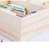 A wooden puzzle box containing several bear-themed dress-up pieces for children.