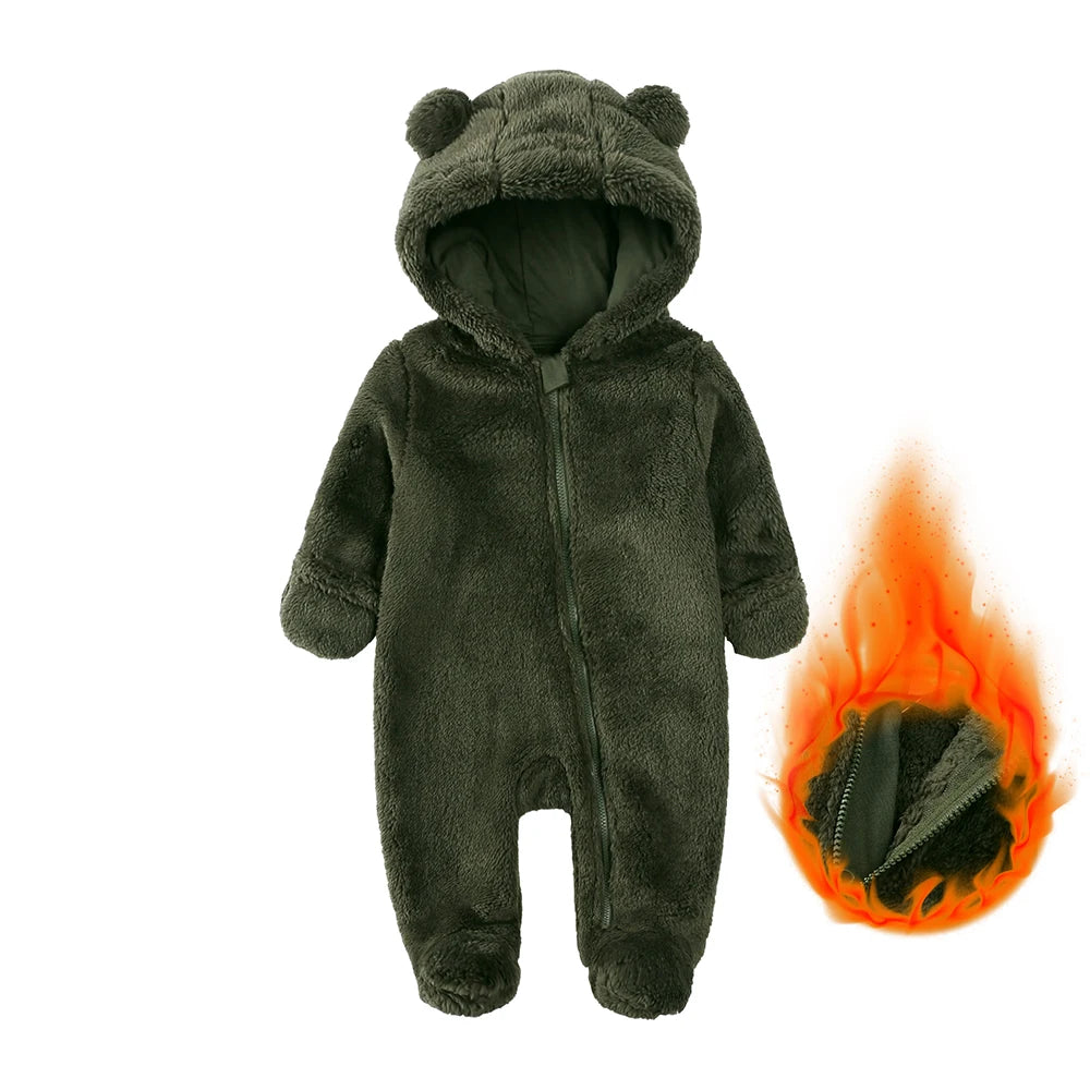 A dark gray fuzzy baby fleece hooded romper with a zipper, shown next to a small flame.