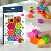 A set of colorful decompression toy blocks and gears being held by a hand on a white surface.