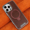 A brown leather case with a magnetic stand design for an iPhone is shown resting on an orange fabric.