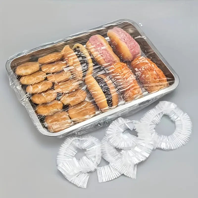 A clear plastic container holds a pack of reusable elastic food covers for bowls and produce lids.