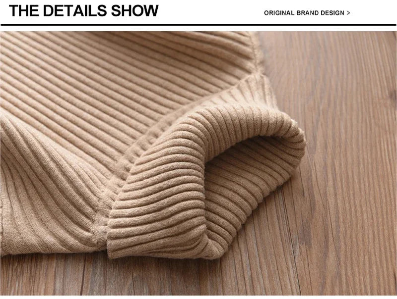 Close-up of a beige ribbed knit turtleneck sweater folded on a wooden surface.