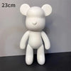 A white bear figurine with large ears standing on a dark surface.