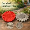 Molde rojo reutilizable para piedras decorativas de girasol con pétalos elevados y centro texturizado sobre superficie de mad