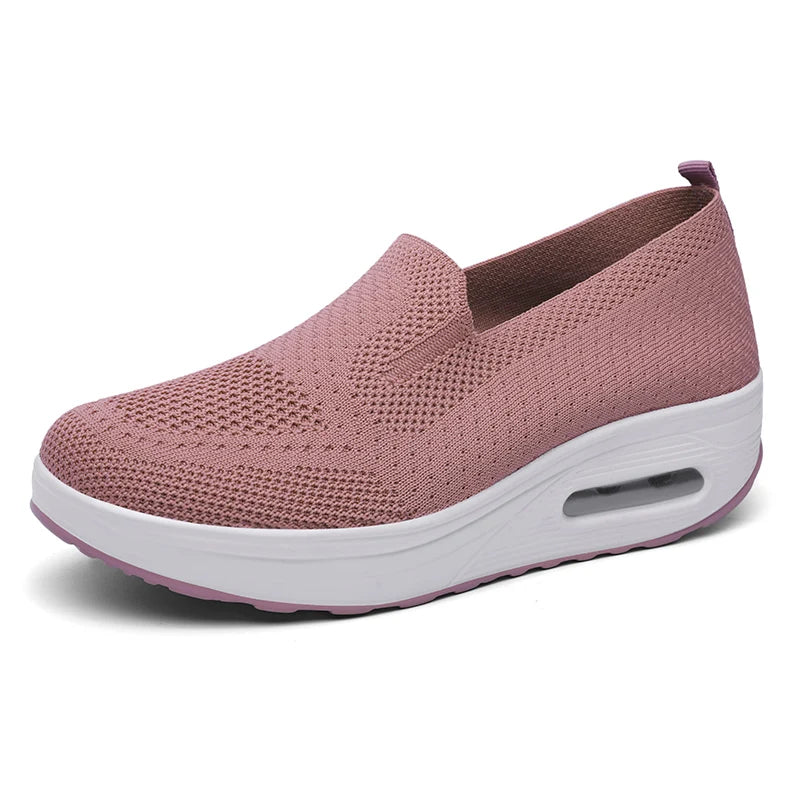 Par de zapatos rosas de mujer con aire acolchado para caminar y suela blanca gruesa.