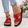 A pair of red breathable mesh flat sandals with a black cushioned sole worn on a person's foot.