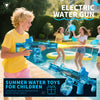 A boy is playing with an electric water gun outdoors, spraying water and creating light effects.
