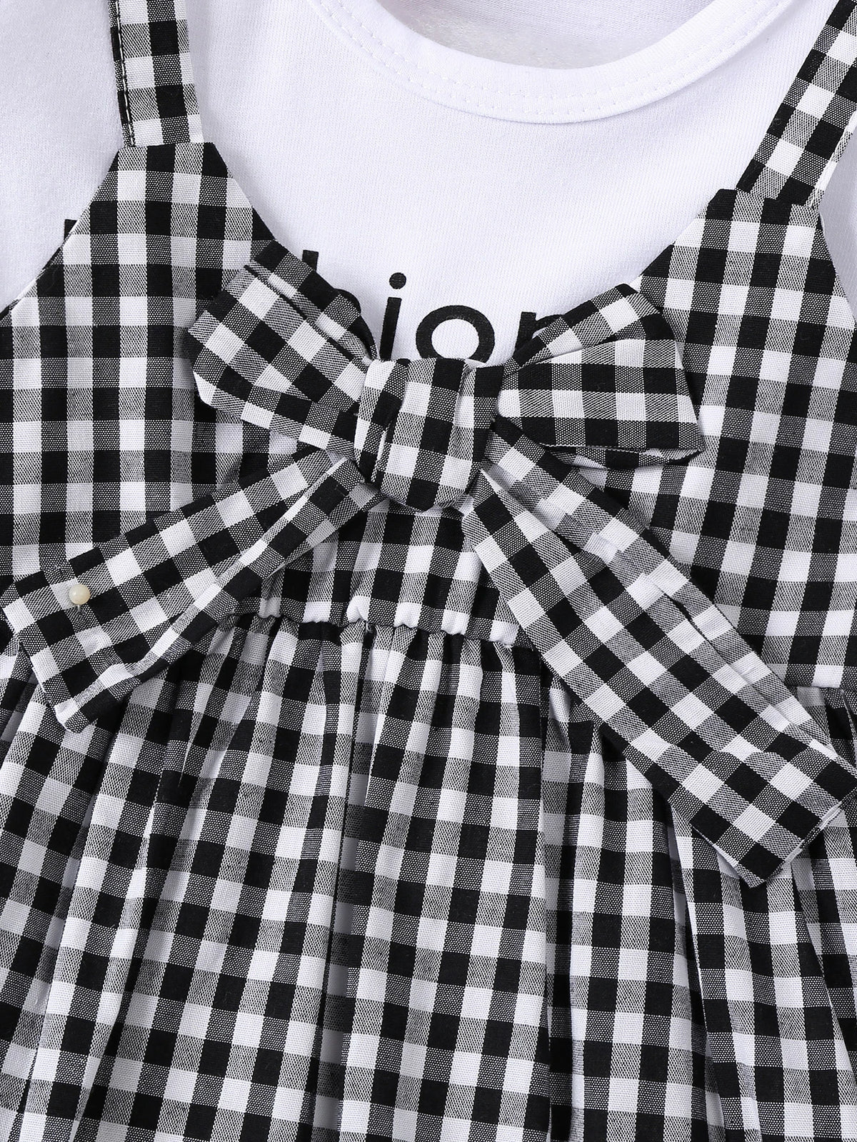 Black and white plaid girls' cotton knit dress with a bow detail