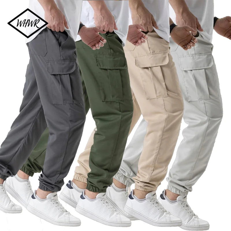 A group of men wearing various colored cargo joggers and white sneakers.