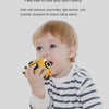 A toddler is biting a yellow rubber toy car designed for baby's biting nature.
