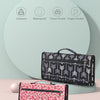 A black patterned portable waterproof baby changing pad is shown next to a pink floral patterned version.